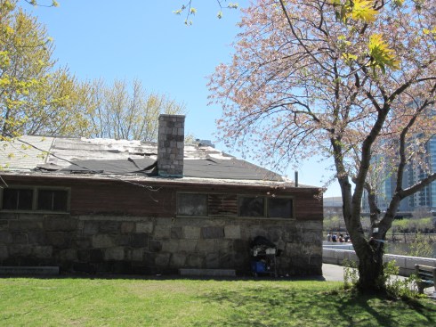 An historically significant building with holes in the roof and lots of graffiti.